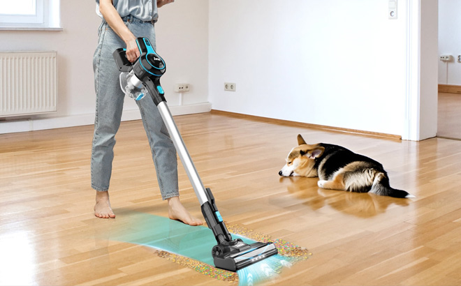 A Person Using Inse Cordless Stick Vacuum