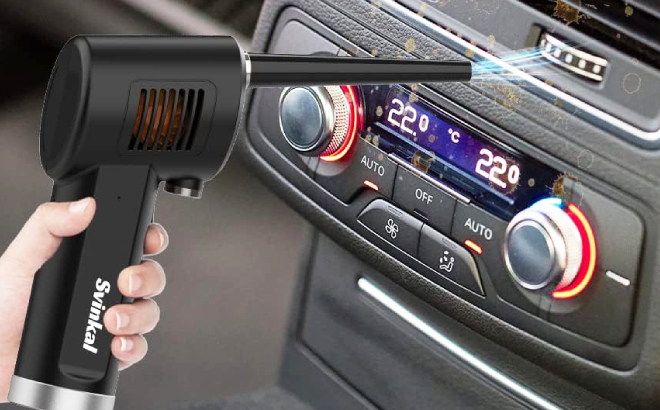 A Person Using Svinkal Handheld Cordless Air Duster to Clean Car Stereo