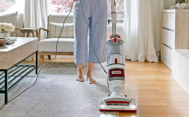 A Person Using a Shark Rotator Upright Vacuum