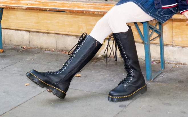 A Person Wearing Dr Martens 1B60 Bex Pisa Leather Knee High Boots