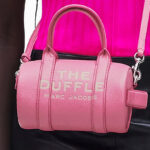 A Person Wearing Marc Jacobs Mini Duffle Bag in Petal Pink Color