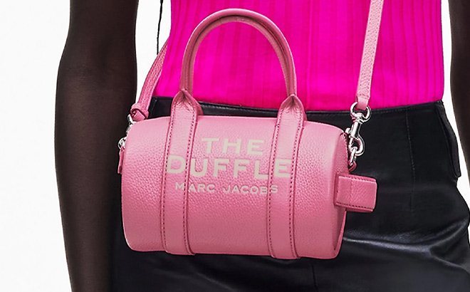 A Person Wearing Marc Jacobs Mini Duffle Bag in Petal Pink Color