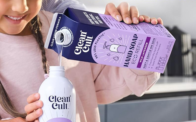 A Person pouring Cleancult 32 Ounce Liquid Hand Soap Refill into a Bottle