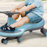 A Person riding a Costway Wiggle Car Ride on Toy