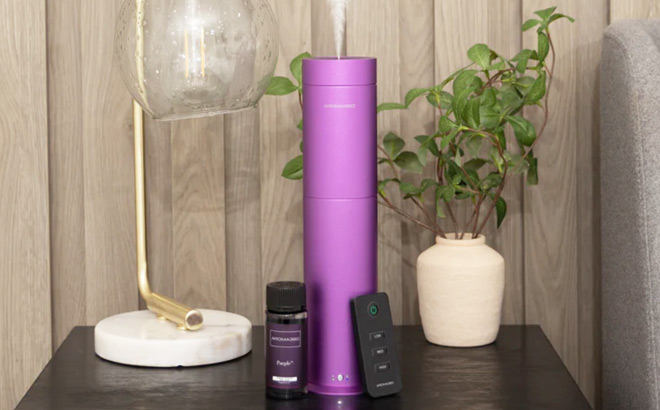 A Purple Aroma360 Mini Pro Scent Diffuser on a Table