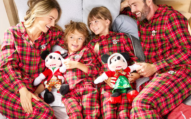 A Smiling Family in Red Matching Disney Holiday Pajamas