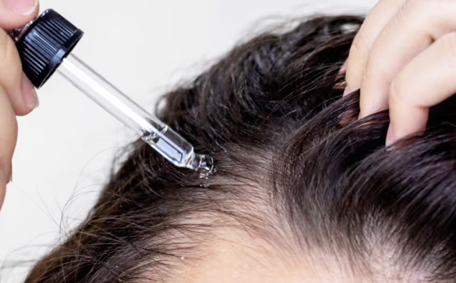 A Woman Applying Hair Growth Serum