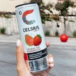 A Woman Holding Celsius Sparkling Strawberry Guava Energy Drink