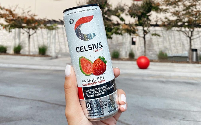 A Woman Holding Celsius Sparkling Strawberry Guava Energy Drink