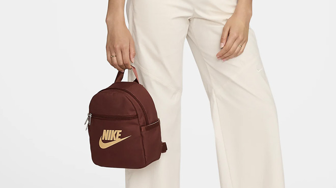 A Woman Holding Nike Sportswear Futura 365 Mini Backpack