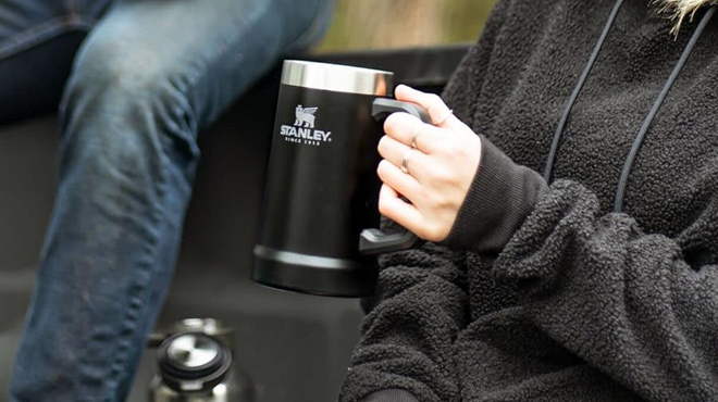 A Woman Holding Stanley Adventure Big Grip Beer Stein