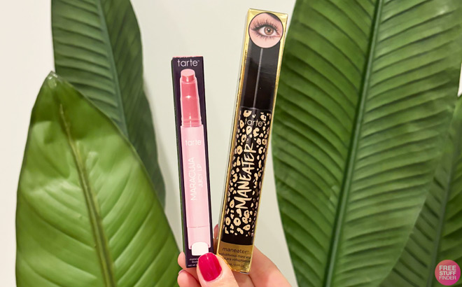 A Woman Holding Tarte Maneater Mascara and Maracuja Juicy Lip Balm