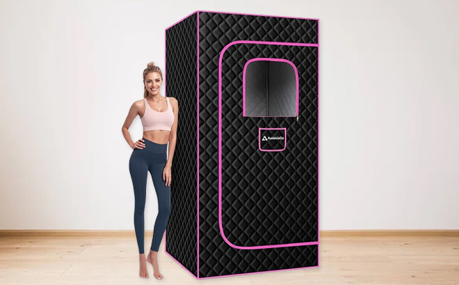 A Woman Standing Next to the AudaciaGo Full Body Portable Steam Sauna