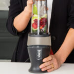 A Woman Using the Ninja Fit Personal Single Serve Blender