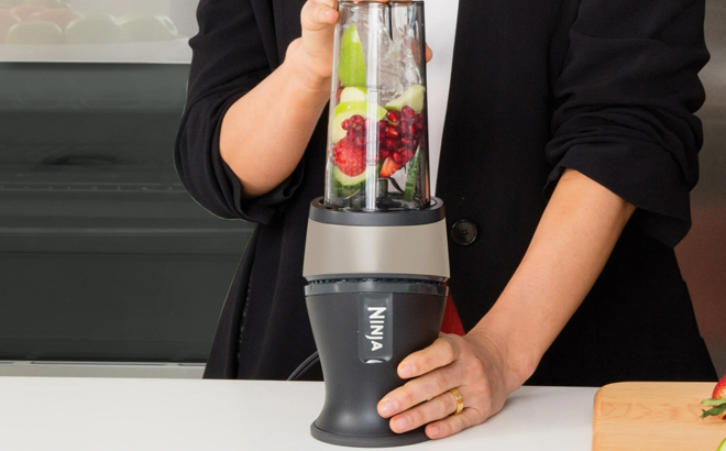 A Woman Using the Ninja Fit Personal Single Serve Blender