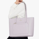 A Woman Wearing Kate Spade Staci Pvc Large Tote Set in Pastel Lavender