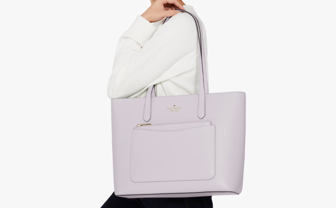 A Woman Wearing Kate Spade Staci Pvc Large Tote Set in Pastel Lavender