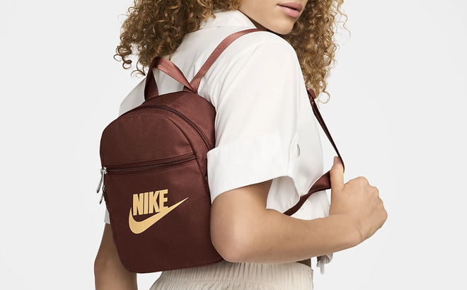 A Woman Wearing Nike Sportswear Futura 365 Mini Backpack