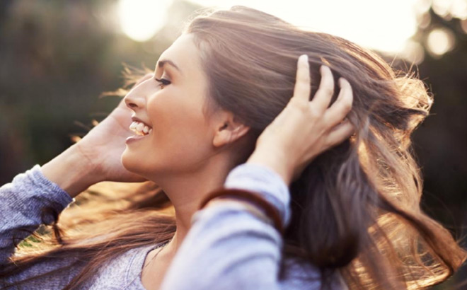 A Woman with Healty Long Brown Hair Smiling