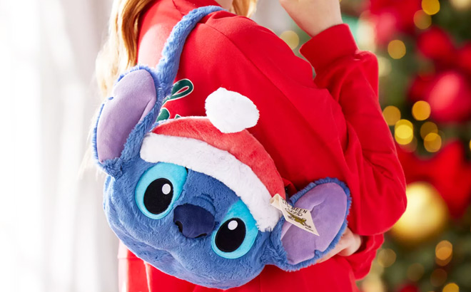 A Woman with Stitch Santa Plush Bag