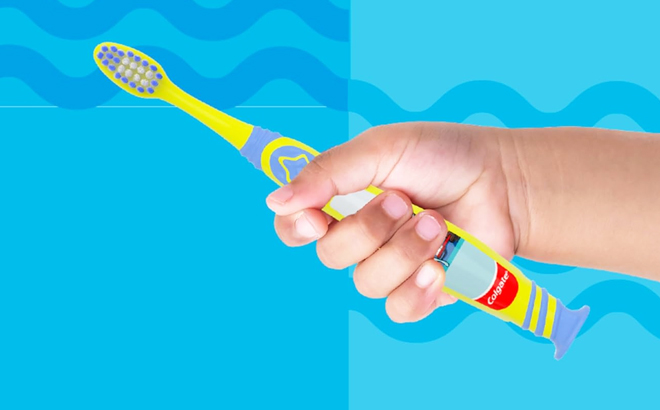 A child holding a Colgate Kids Toothbrush