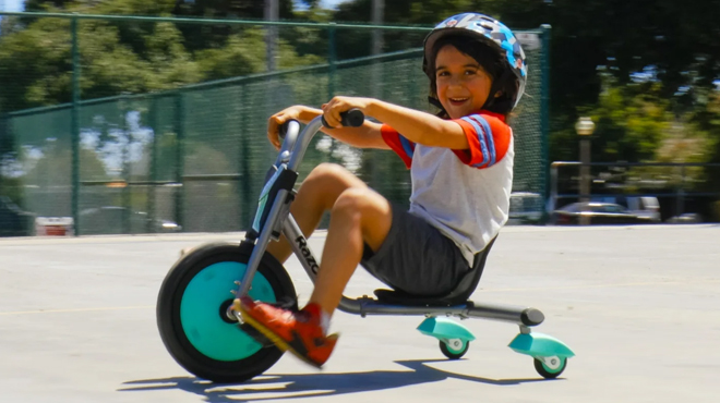 A child riding a Razor RipRider 360 Mini Caster Tricycle