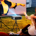 A couple watching a movie outdoor using Fudoni Portable Home Theater Projector