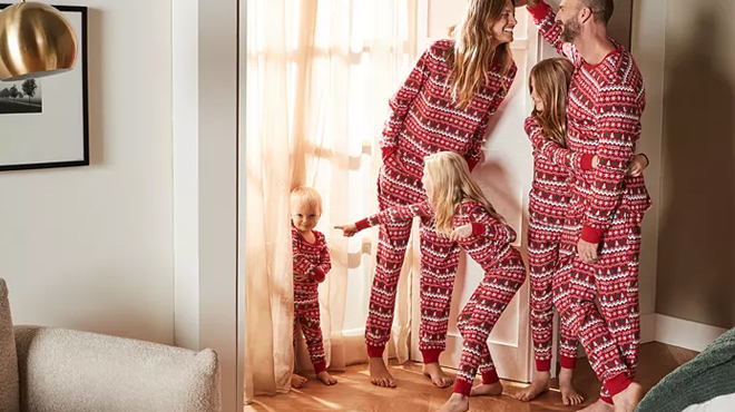 A family wearing Holiday Lane Merry Matching Family Pajama Sets