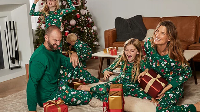 A family wearing Holiday Lane Ornament Matching Family Pajama Sets