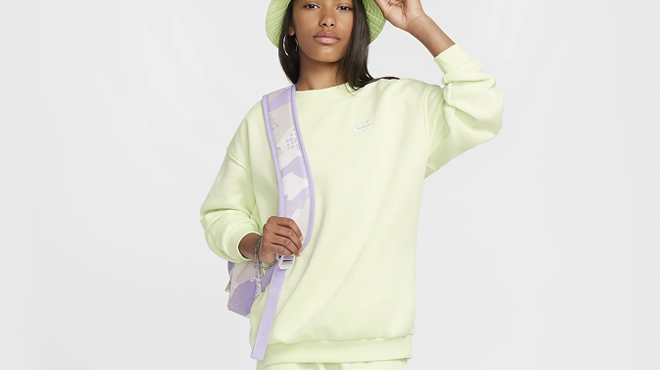 A girl wearing a Nike Big Kids Oversized Sweatshirt