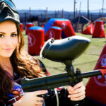 A lady holding a Paint Ball Rifle