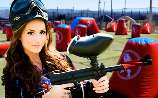 A lady holding a Paint Ball Rifle