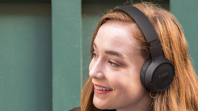 A lady putting on a JBL Tune 510BT Headphones