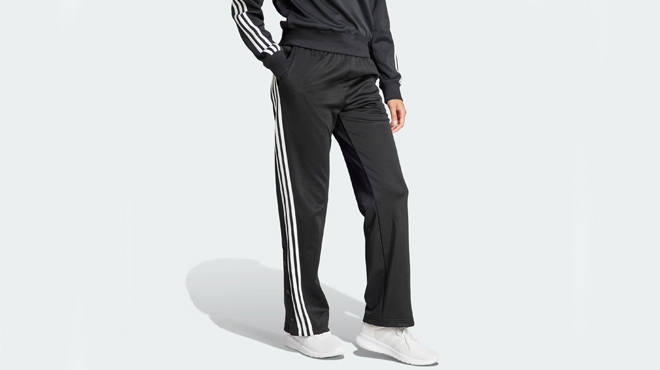 A lady wearing a Adidas Womens 3 Stripes Snap Track Pants