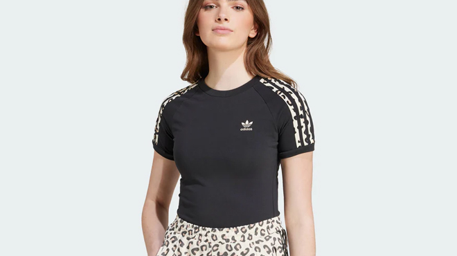 A lady wearing a Adidas Womens Leopard 3 Stripes Tee