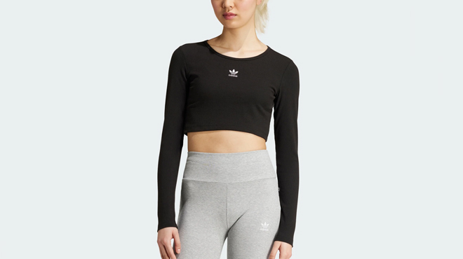 A lady wearing an Adidas Womens Ribbed Crop Long Sleeve Tee