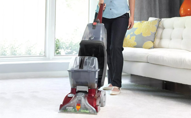 A person Using Hoover PowerScrub Deluxe Carpet Cleaner