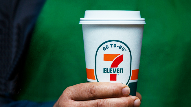 A person holding a 7 Eleven coffee