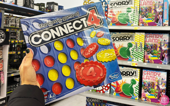 A person holding a Connect 4 Classic Kids Board Game