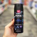 A person holding an Axe Premium Body Spray