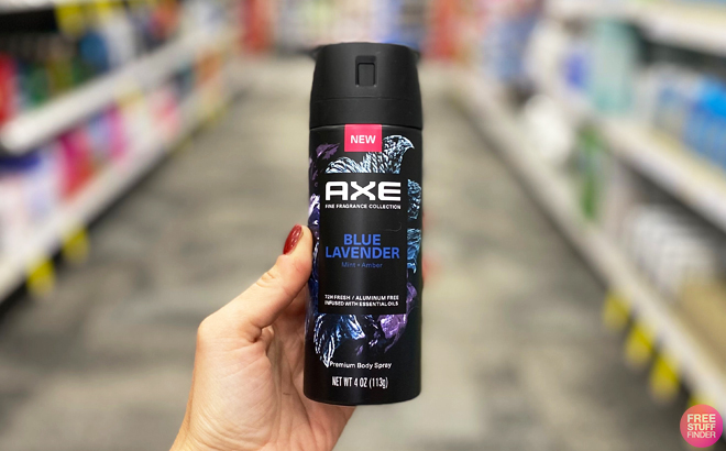 A person holding an Axe Premium Body Spray