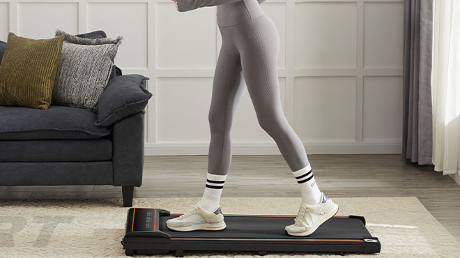 A person using Olixis Compact Armless Treadmill