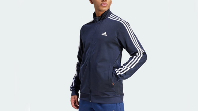 A person wearing Adidas Mens Warm up 3 Stripes Track Jacket