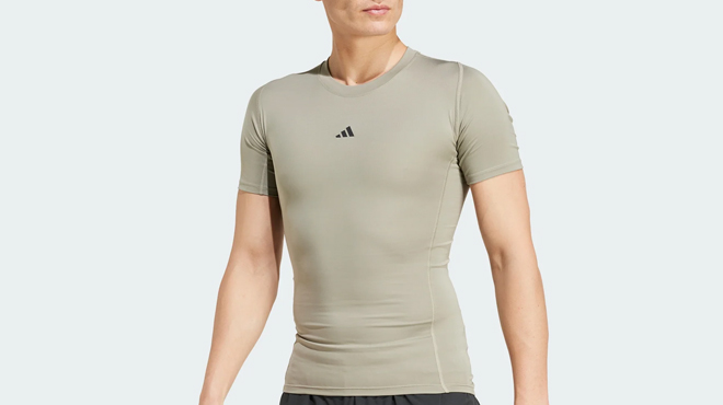 A person wearing a Adidas Mens Techfit Compression Training Tee