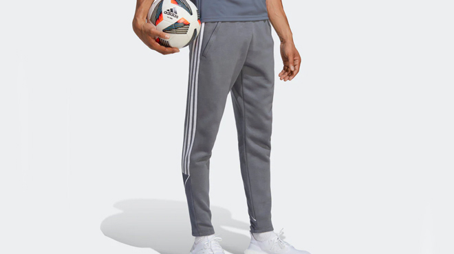 A person wearing a Adidas Mens Tiro 23 Leauge Sweat Pants