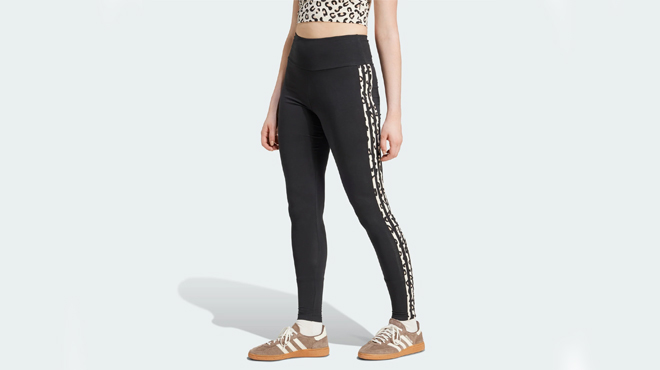 A person wearing aAdidas Womens Leopard Allover Print Leggings