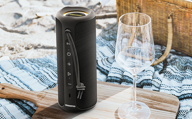 Miatone Bluetooth Speaker beside a wine glass