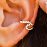 Pura Vida Rose Gold Stone Wave Ear Cuff on an Ear