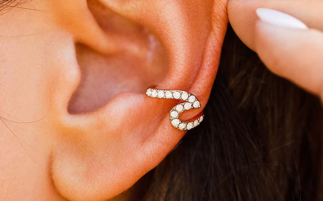 Pura Vida Rose Gold Stone Wave Ear Cuff on an Ear