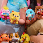 Two Girls Holding the Zuru Snackles Mystery Plushies